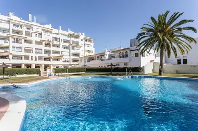 a large swimming pool in front of a building at Vistahermosa 2 Rooms Piscina in El Puerto de Santa María