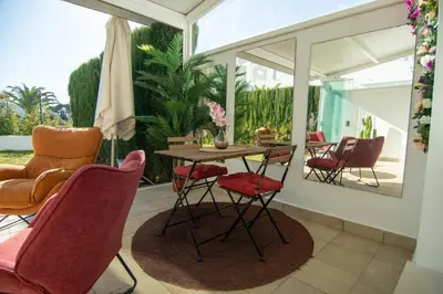 a room with a table and chairs on a patio at Casa PLAYA FONTANILLA in Conil de la Frontera