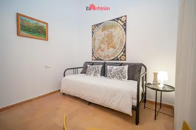 a bedroom with a bed with a map on the wall at El Anfitrión - Palacio XVIII in Sanlúcar de Barrameda
