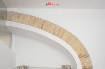 a spiral staircase in a building with a white ceiling at El Anfitrión - Palacio XVIII in Sanlúcar de Barrameda