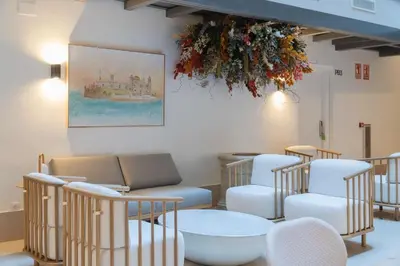 a waiting room with chairs and a table at La Caleta QE Hotels in Cádiz