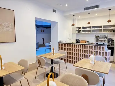 a restaurant with tables and chairs and a counter at La Caleta QE Hotels in Cádiz