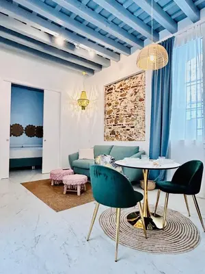 a living room with a couch and a table and chairs at inncadiz Los Balbos apartment in Cádiz