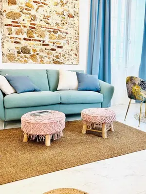 a living room with a blue couch and two tables at inncadiz Los Balbos apartment in Cádiz