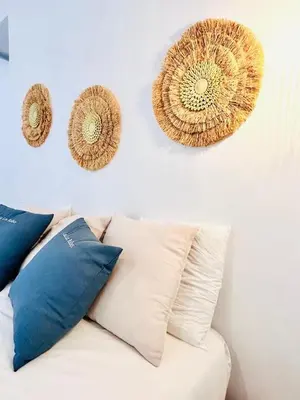 a white couch with pillows on a white wall at inncadiz Los Balbos apartment in Cádiz
