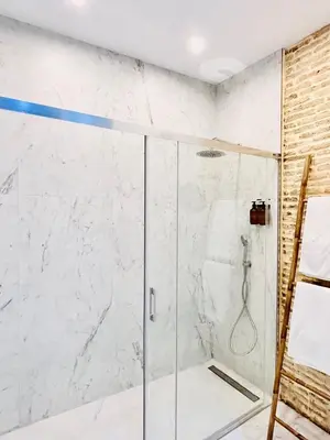 a shower with a glass door in a bathroom at inncadiz Los Balbos apartment in Cádiz