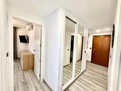 an empty room with a mirror and a hallway at alsur by Staycare in Jerez de la Frontera