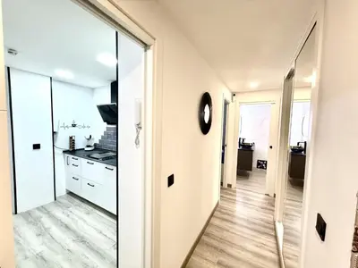 a kitchen with white cabinets and a large mirror at alsur by Staycare in Jerez de la Frontera