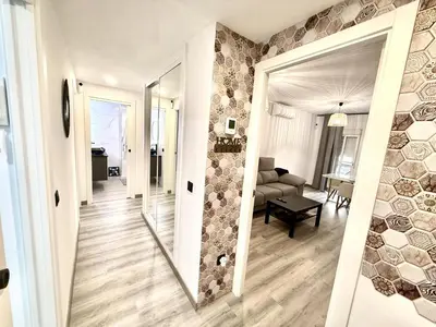 a hallway leading to a living room with a mirror at alsur by Staycare in Jerez de la Frontera