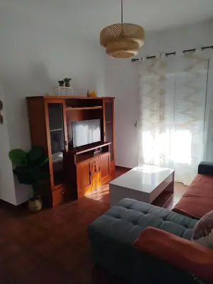 a living room with a couch and a tv at Brisa&Mar, con Posibilidad de Parking in Chipiona
