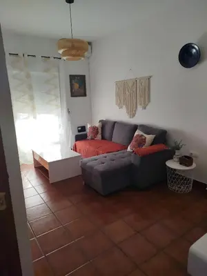 a living room with a couch and a table at Brisa&Mar, con Posibilidad de Parking in Chipiona
