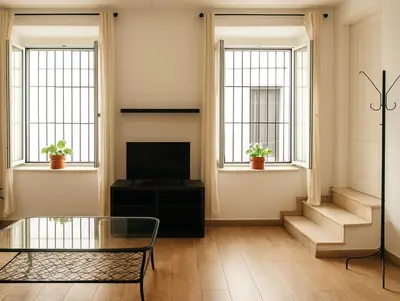 a living room with a television and two windows at Check-in autónomo Centro Histórico Todo a pie Ideal para parejas in Jerez de la Frontera