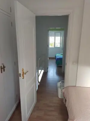 a hallway with a room with a bed and a door at Mi Rinconcito de El Manantial in El Puerto de Santa María