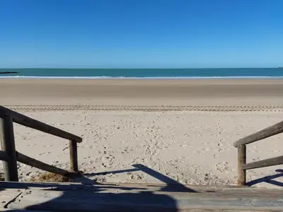 a view of a beach with a wooden railing on it at Mi Rinconcito de El Manantial in El Puerto de Santa María