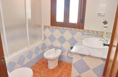 a bathroom with a toilet and a sink at Villa Ureba in Conil de la Frontera