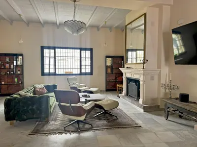 a living room with a couch and chairs and a fireplace at Palacio Jaramago - Ole Solutions in Jerez de la Frontera