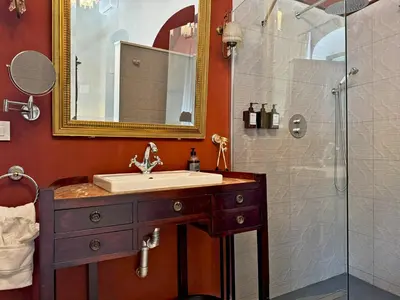 a bathroom with a sink and a shower with a mirror at Palacio Jaramago - Ole Solutions in Jerez de la Frontera
