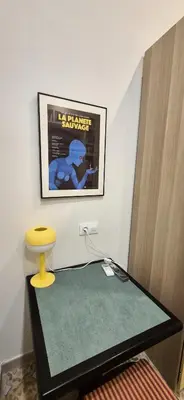 a room with a table with a toilet and a poster at Santa Catalina by Gades Gestión in Cádiz