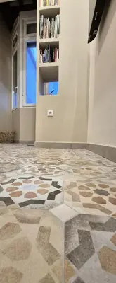 a room with a tiled floor with a book shelf at Santa Catalina by Gades Gestión in Cádiz