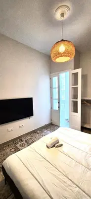 a bedroom with a large bed with a phone on it at Santa Catalina by Gades Gestión in Cádiz