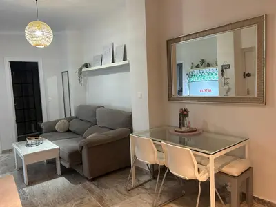 a living room with a couch and a glass table at Apartamento Sol y Playa in Rota