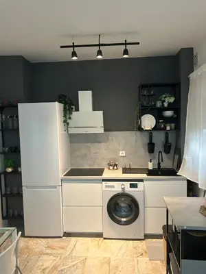 a kitchen with a washing machine and a washer at Apartamento Sol y Playa in Rota