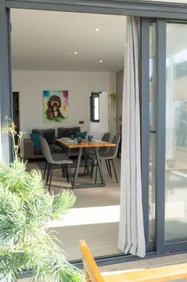 a living room and dining room with a table and chairs at Apartamento - Casa Trufa in Conil de la Frontera