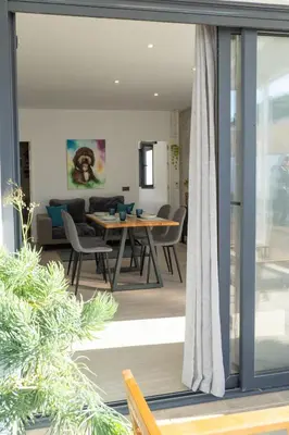 a dining room and living room with a table and chairs at Apartamento - Casa Trufa in Conil de la Frontera