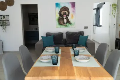 a dining room with a table and a couch at Apartamento - Casa Trufa in Conil de la Frontera