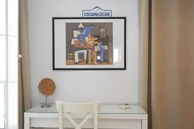 a room with a desk and a picture on the wall at Casa 4 - Capuchinos in Sanlúcar de Barrameda