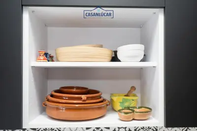 a shelf with bowls and plates in a refrigerator at Casa 4 - Capuchinos in Sanlúcar de Barrameda
