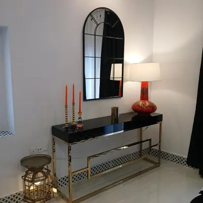 a table with a mirror and a lamp on it at Beautiful penthouse with terrace next to the Cathedral in Cádiz