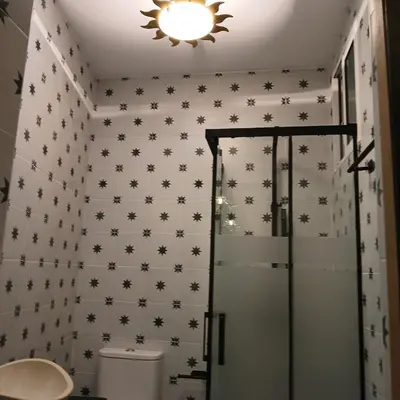 a bathroom with a shower with black stars on the wall at Beautiful penthouse with terrace next to the Cathedral in Cádiz