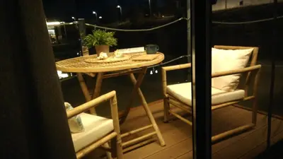 a small table and two chairs on a balcony at Casa Flotante El Refugio del Pirata in El Puerto de Santa María