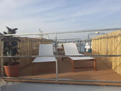 two white chairs sitting on the deck of a boat at Casa Flotante El Refugio del Pirata in El Puerto de Santa María