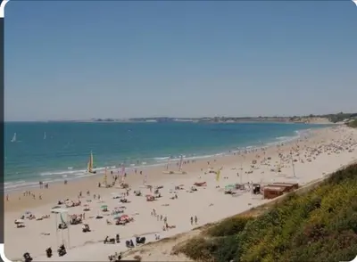 a group of people on a beach with the ocean at Playa Las Redes in El Puerto de Santa María