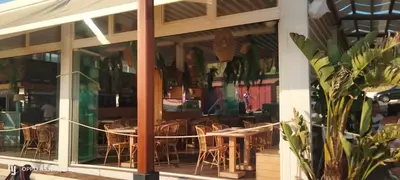 a restaurant with a table and chairs in the window at Playa Las Redes in El Puerto de Santa María