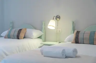a bedroom with two beds and a lamp on a table at Apartoyou - Vistahermosa vistas in El Puerto de Santa María