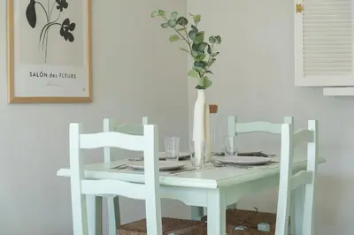 a white table with two white chairs and a vase at Apartoyou - Vistahermosa vistas in El Puerto de Santa María