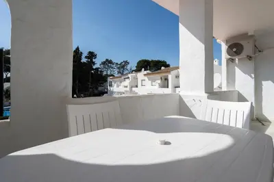 a white table and white chairs on a balcony at Apartoyou - Vistahermosa vistas in El Puerto de Santa María