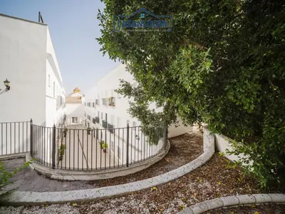 a fence in front of a white building at Carmen Viejo primero in Sanlúcar de Barrameda