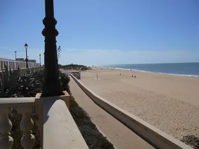 a view of the beach from a fence at Apartamento Caracola Comfortable holiday residence in Chipiona