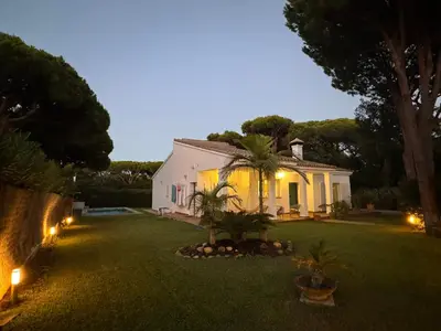a house with lights in a yard at night at VillaMarte in Conil de la Frontera
