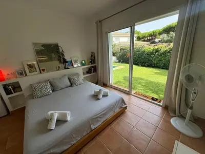 a bedroom with a bed and a large window at VillaMarte in Conil de la Frontera