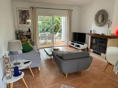 a living room with a couch and a fireplace at VillaMarte in Conil de la Frontera