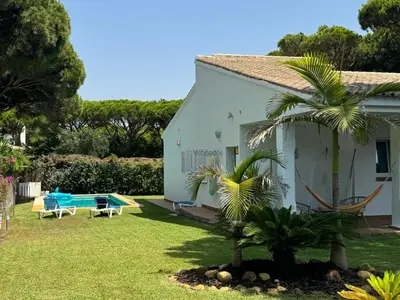 a white house with a yard with a pool at VillaMarte in Conil de la Frontera