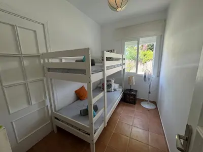 a room with two bunk beds and a window at VillaMarte in Conil de la Frontera