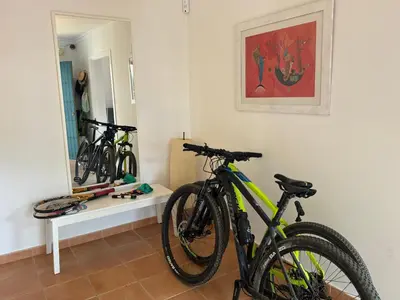 a bike parked in a room with a mirror at VillaMarte in Conil de la Frontera