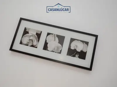 a picture frame with four lights on a wall at Carmen Viejo bajo in Sanlúcar de Barrameda