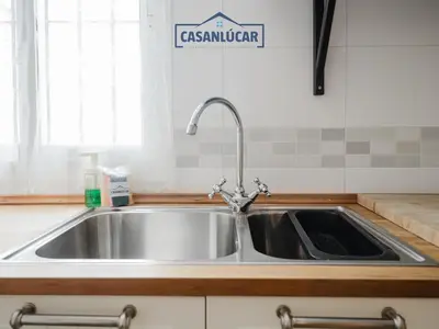 a stainless steel sink in a kitchen with a window at Carmen Viejo bajo in Sanlúcar de Barrameda